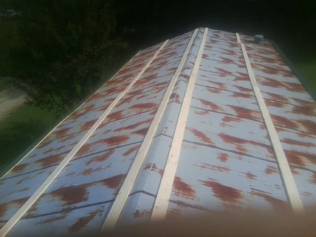 Rusted metal roof panels with new wood purlins before replacement — Storm Damage Roof Repair in Altaville by Roofing Brothers