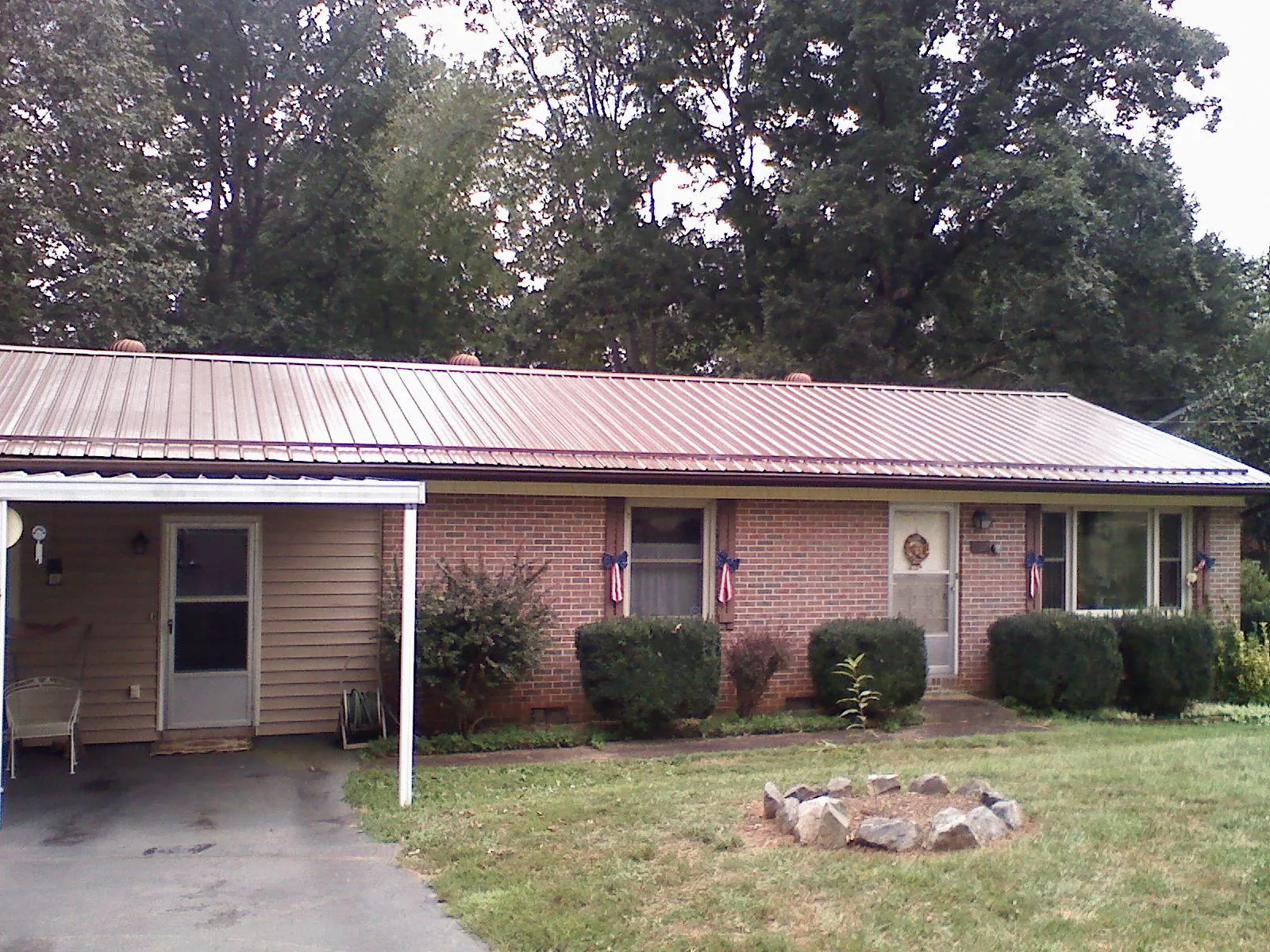 Bronze metal roof and carport on a brick ranch home — Roof Repair work by our crew in Altaville